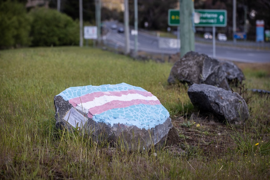 Rock memorial on a grassy area.