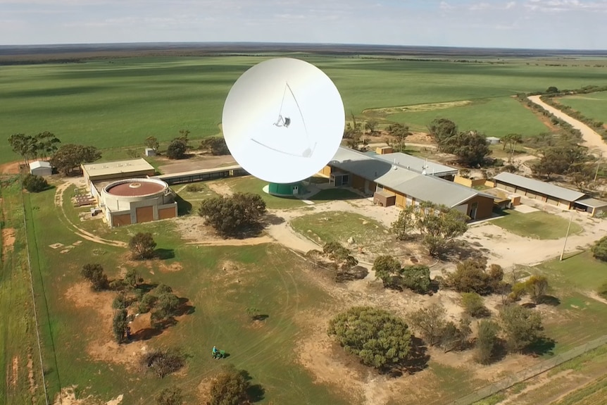 A drone view of a radio telescope in the fields.