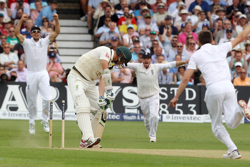 Alastair Cook (L) and Ian Bell react as Mark Wood (R) bowls Australia's Josh Hazlewood.