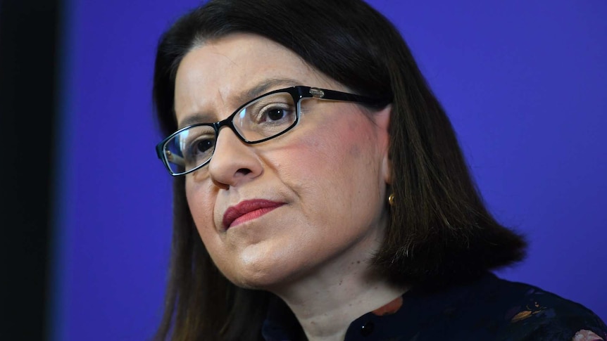 A close-up of Victorian Health Minister Jenny Mikakos, who looks serious during a press conference.