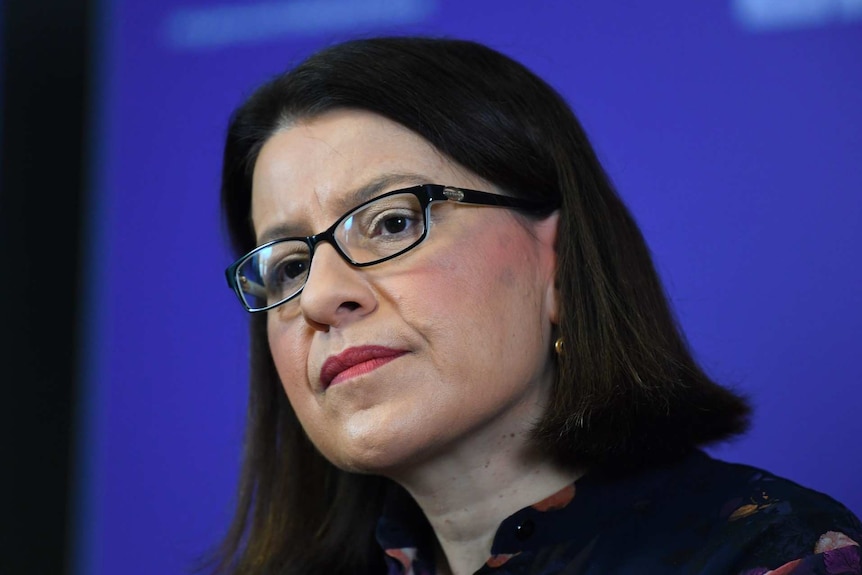 A close-up of Victorian Health Minister Jenny Mikakos, who looks serious during a press conference.