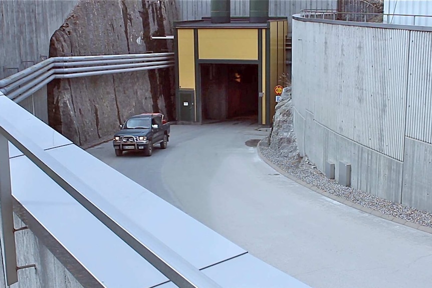 A car drives out of the Olkiluoto nuclear power plant.