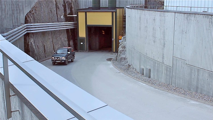 A car drives out of the Olkiluoto nuclear power plant.