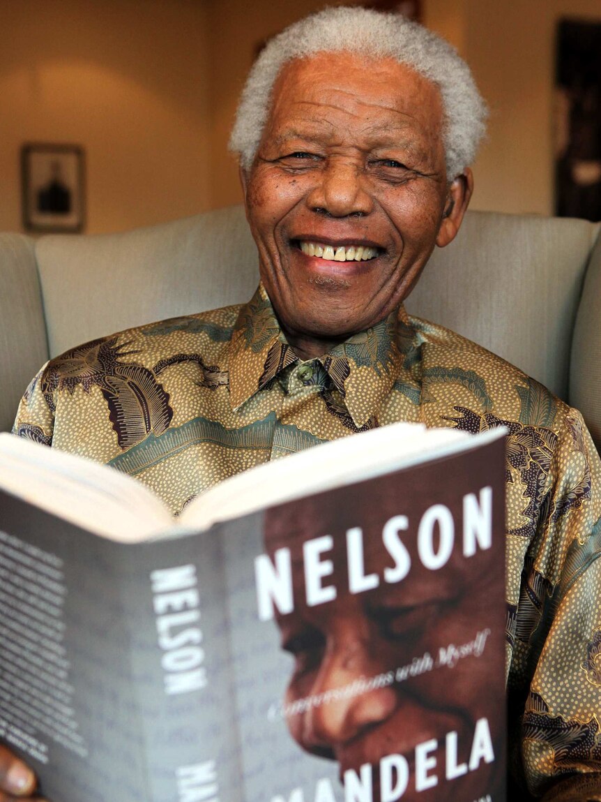 Nelson Mandela with a copy of his book "Coversations with Myself"