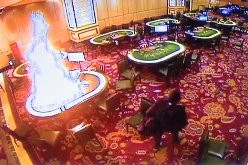 CCTV footage of a card table on fire in the Resorts World Manila casino.