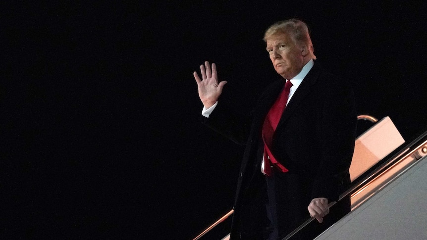 President Donald Trump waves as he arrives at Atlantic City International Airport