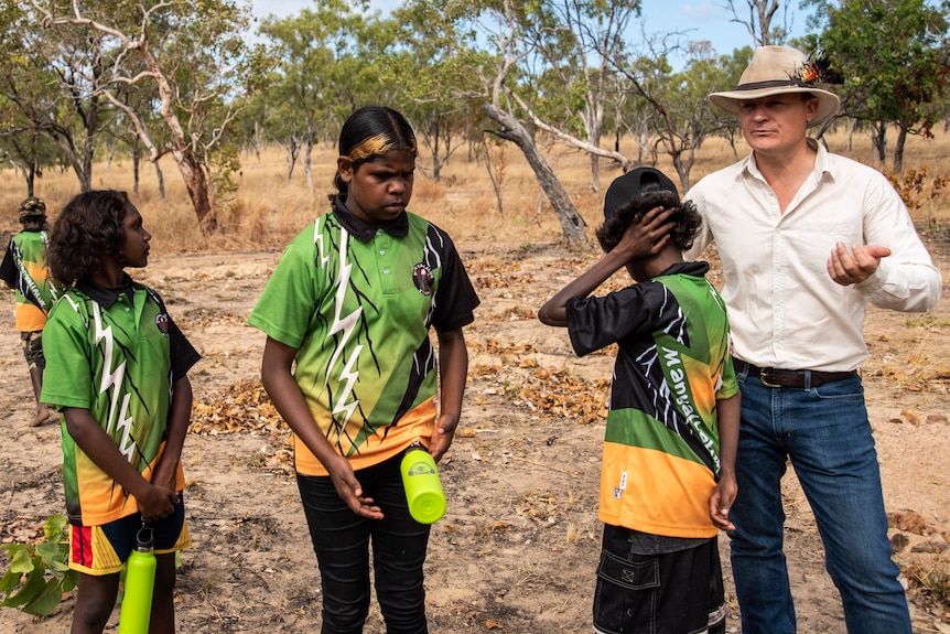 Students stand near their principal in outback NT. 