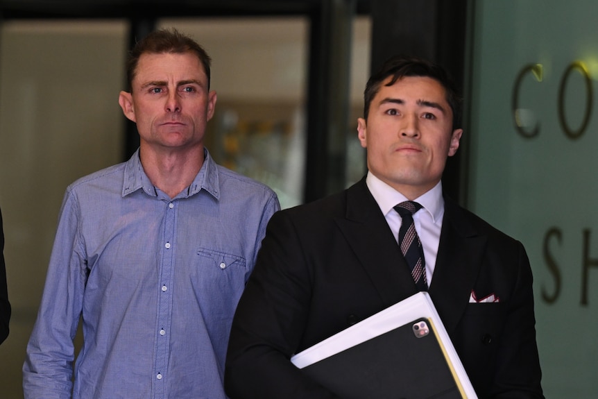 Daniel Muston, left, and lawyer Bryan Wrench, right, walking outside Downing Centre Local Court