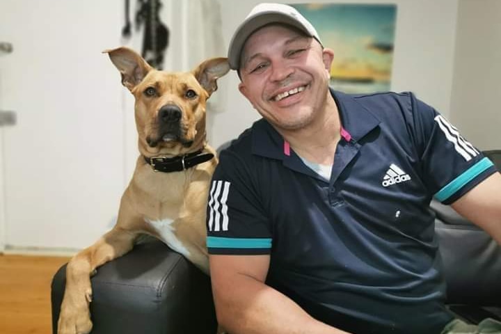 man with dog smiling