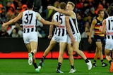 Jaidyn Stephenson and Adam Treloar celebrate a goal for Collingwood against the Adelaide Crows.
