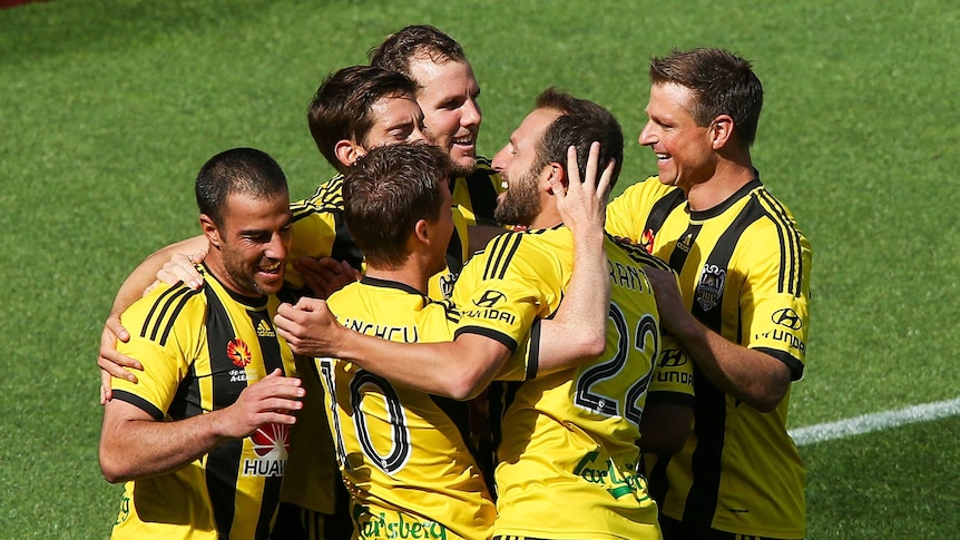 Manny Muscat (L) of the Phoenix is congratulated on his goal by teammates
