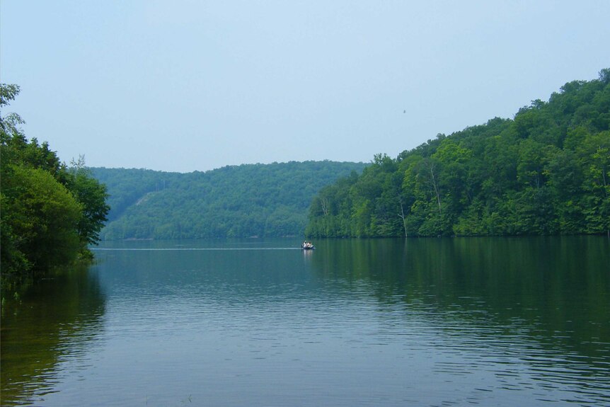 A wide shots shows the Hudson River surrounded by trees.