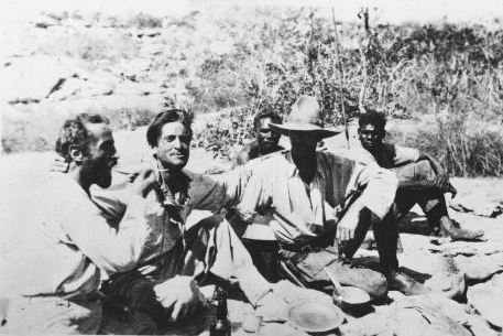A black and white picture of Adolph Klausmann, Hans Bertram, Gordon Marshall and two Aboriginal men sitting on the ground.