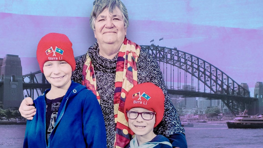 A woman embraces her two grandsons in front of the Sydney Harbour Bridge.