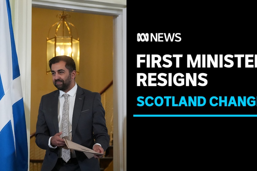 First Minister Resigns, Scotland Change: Man in suit walks through doorway next to blue and white Scottish flag.