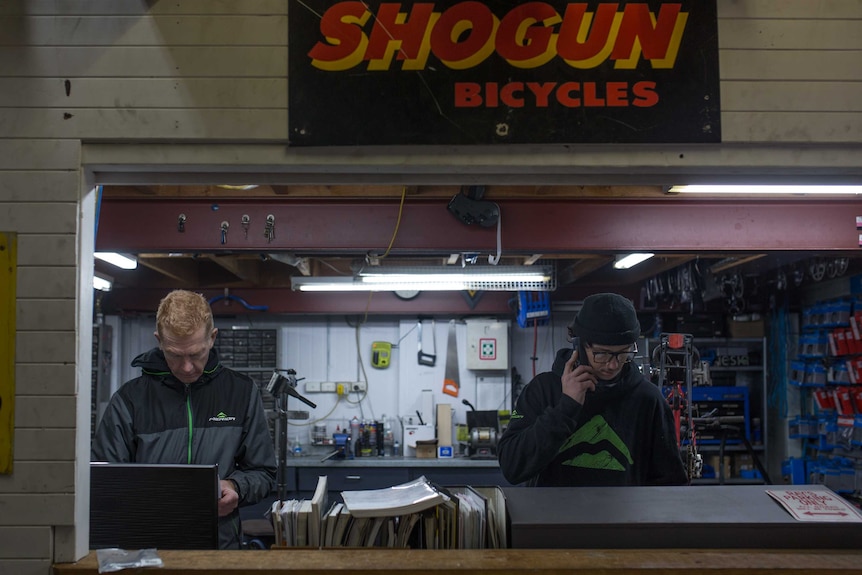 Mike and one of his staff members in the bike shop workshop