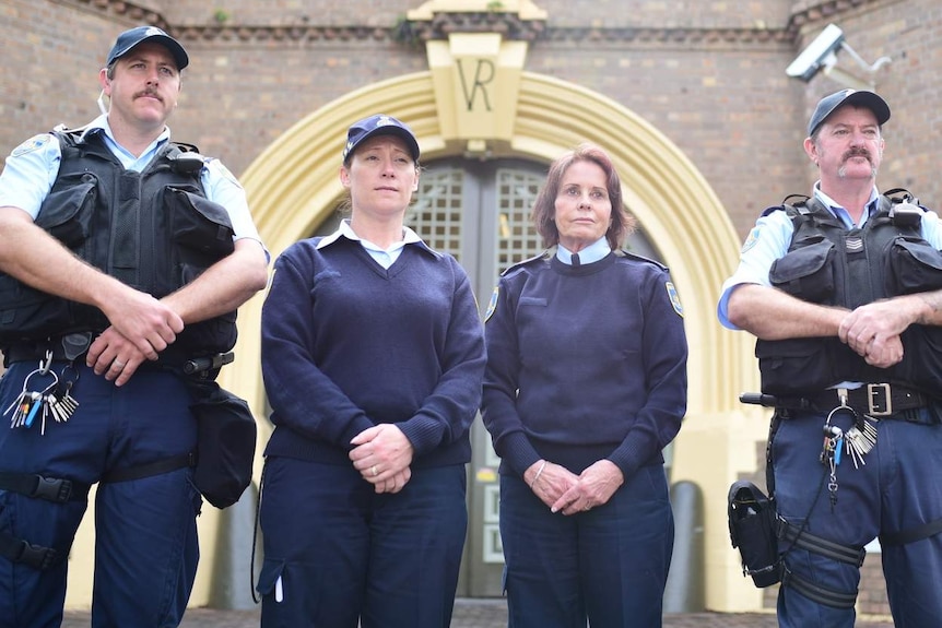 Prison staff stand outside main gate