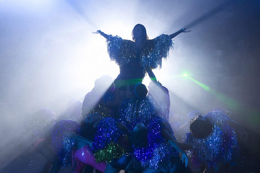 Still image from 2018 film A Fantastic Woman of Daniela Vega lifted in the air during a musical sequence.