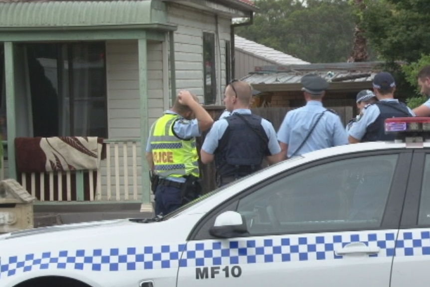 Police standing outside a house.