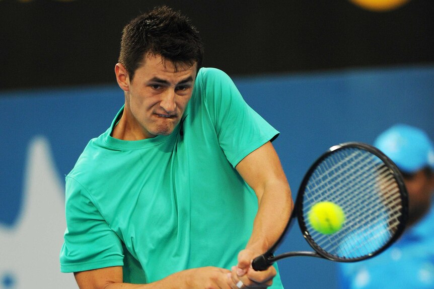 Finals appearance ... Bernard Tomic plays a backhand return to Kevin Anderson