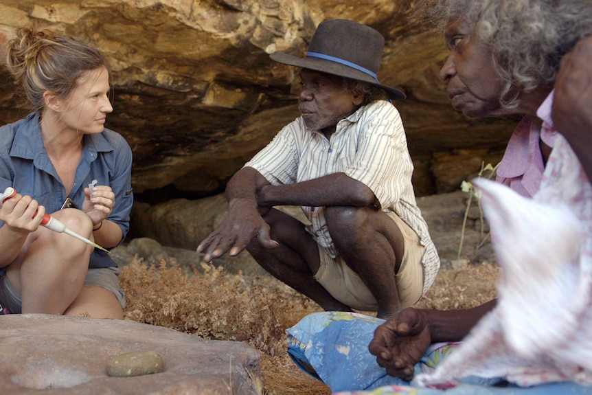 Scientists and a traditional owner take a sample at a cave in Kakadu National Park.