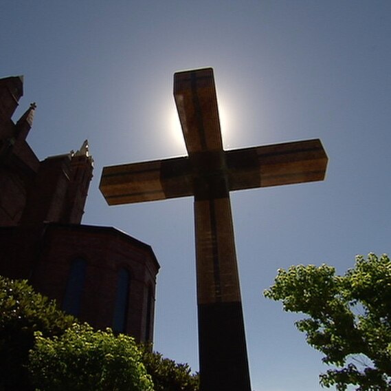 A crucifix stands outside a church.