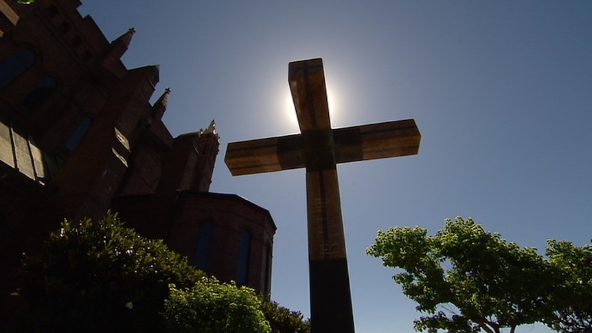 A crucifix stands outside a church.