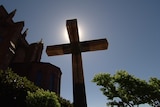 A crucifix stands outside a church.