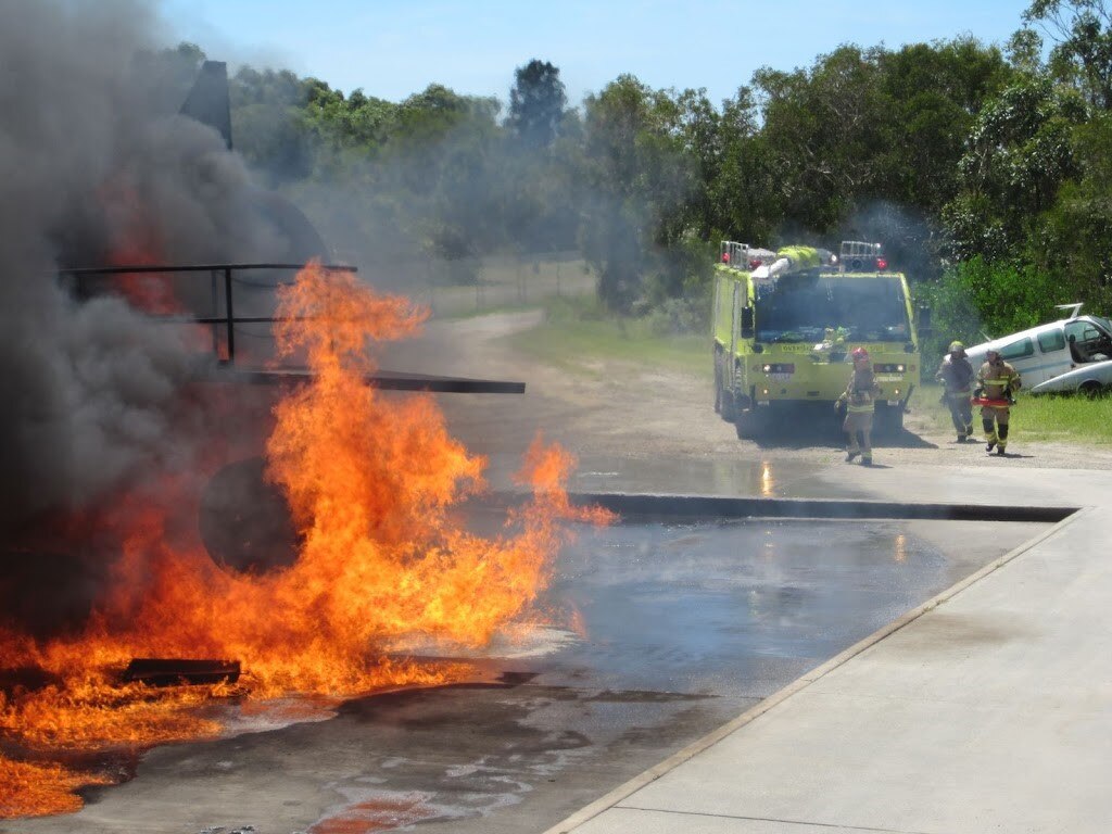 A large blaze on cement, which fire crews are rushing towards.