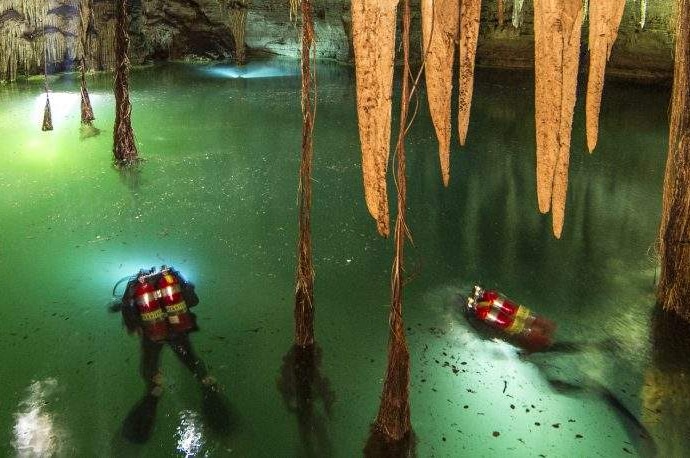 Divers explore Cenote Holtun, a sinkhole in the Chichen Itza area in Mexico.
