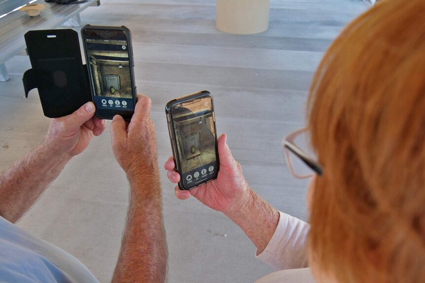 Tourists looking at augmented reality app on phones