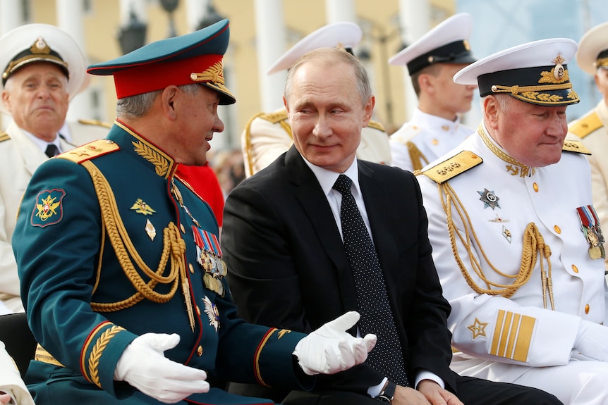 Putin and Shoigu smiling at each other 
