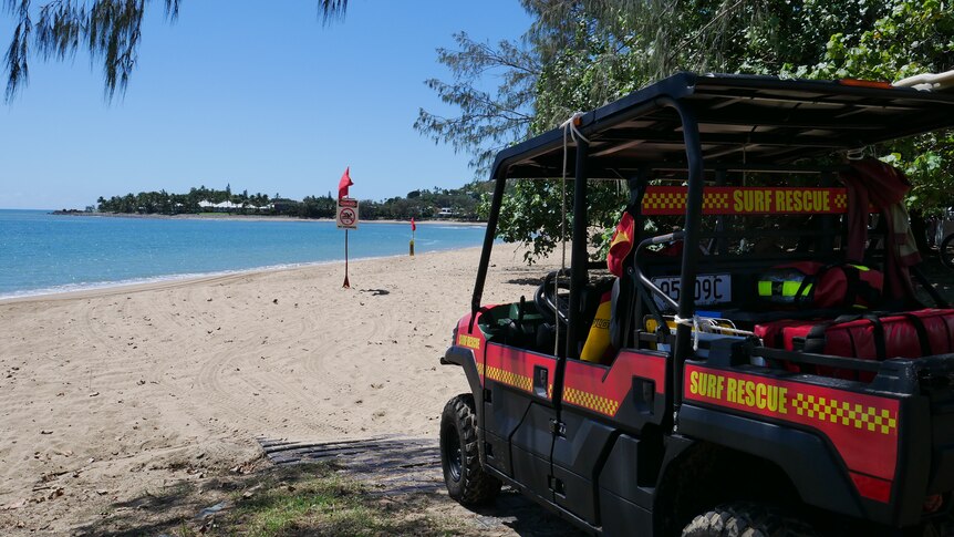 A surf lifesaving vehicle at the entry to a beach with a beach closed sign