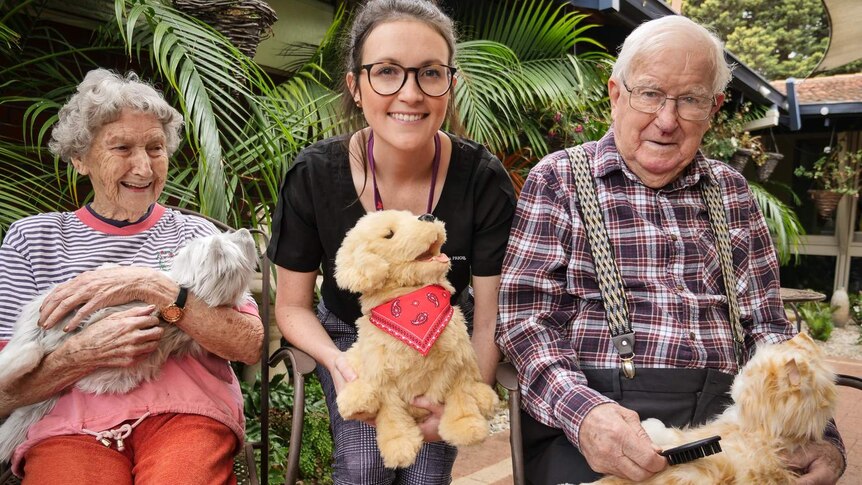 Madelyne Glover with two aged care residents