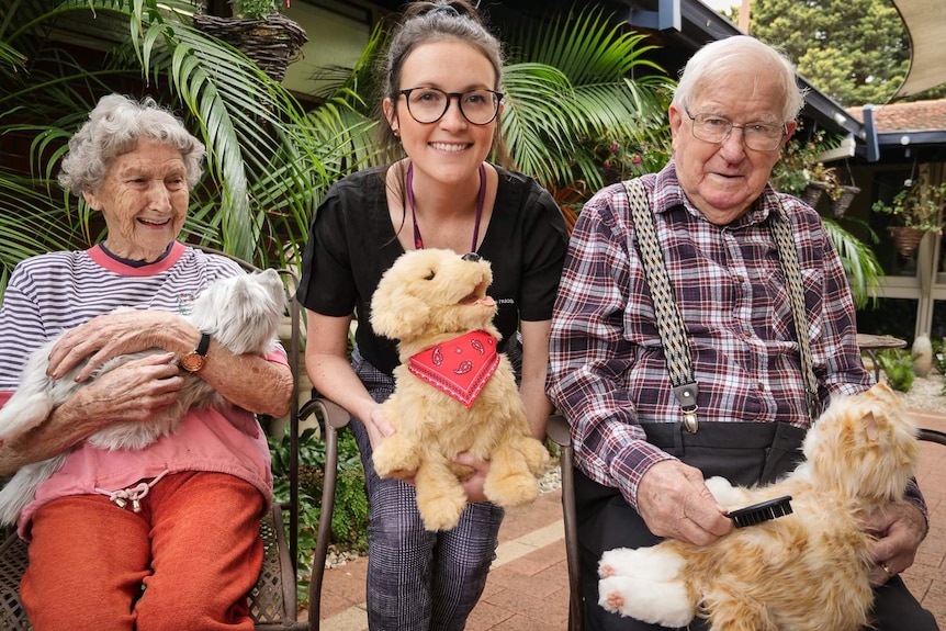 Madelyne Glover with two aged care residents