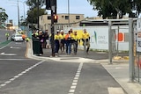 Construction workers leave the Royal Adelaide Hospital worksite.