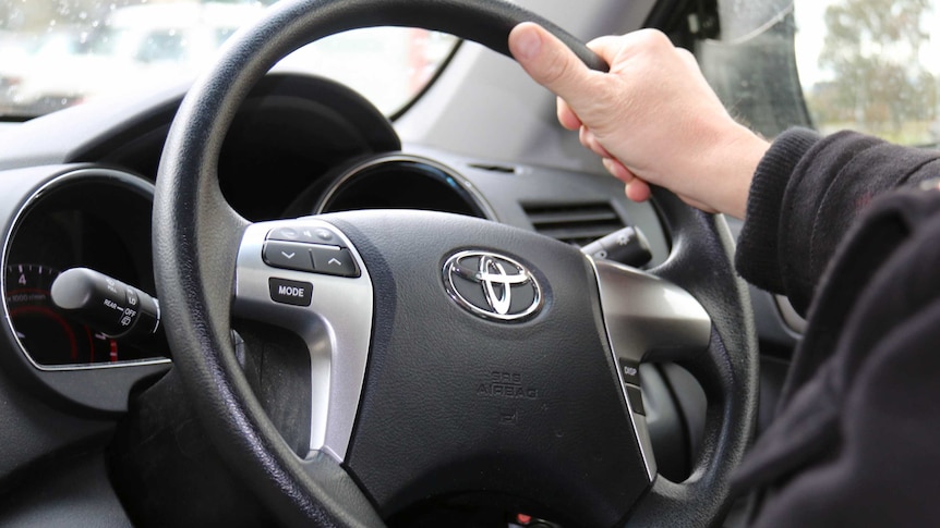 Hands on car steering wheel. *Generic. Sept 2014.