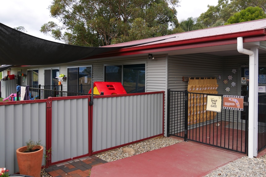 The entrance to a childcare centre, with a sign saying shut the gate