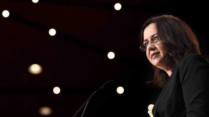 Queensland Premier Annastacia Palaszczuk speaks into microphone.