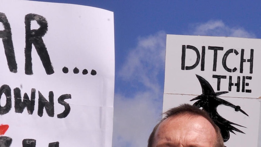 Tony Abbott addressed the group of about 3,000 people in front of the placards.
