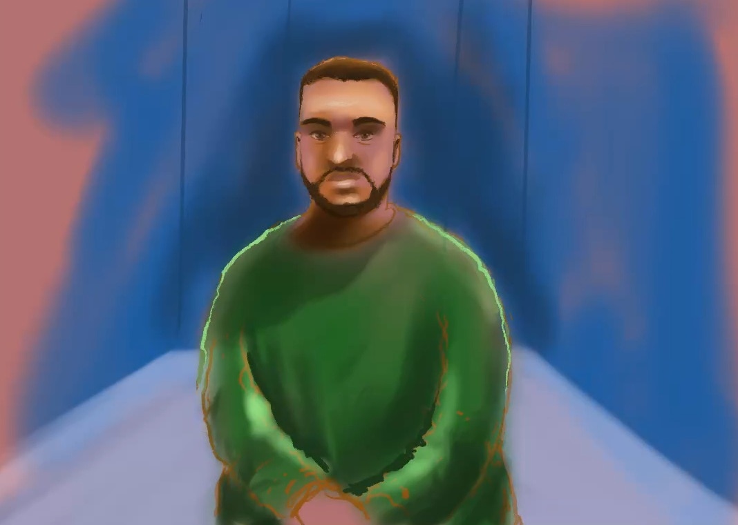 Naveed Akram appears on a screen in a courtroom setting, wearing a prison uniform.