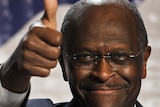 US Republican presidential hopeful Herman Cain gives the thumbs up