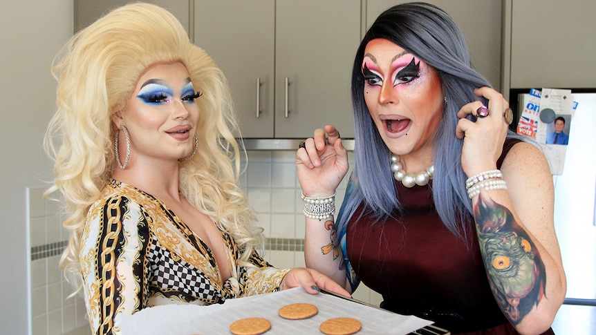 Ellawarra holds a tray of biscuits in the kitchen while Roxee Horror looks at them surprised.