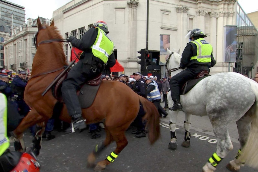 Mounted police clash with anti-fascist protesters.