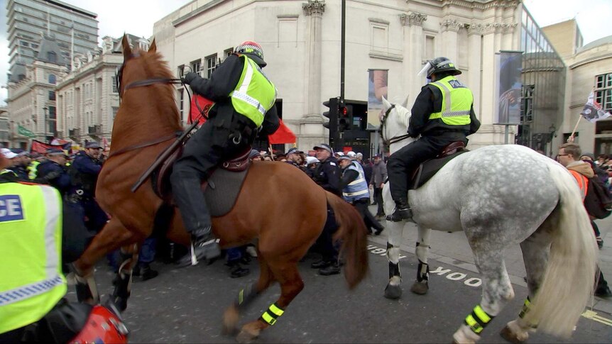 Mounted police clash with anti-fascist protesters.