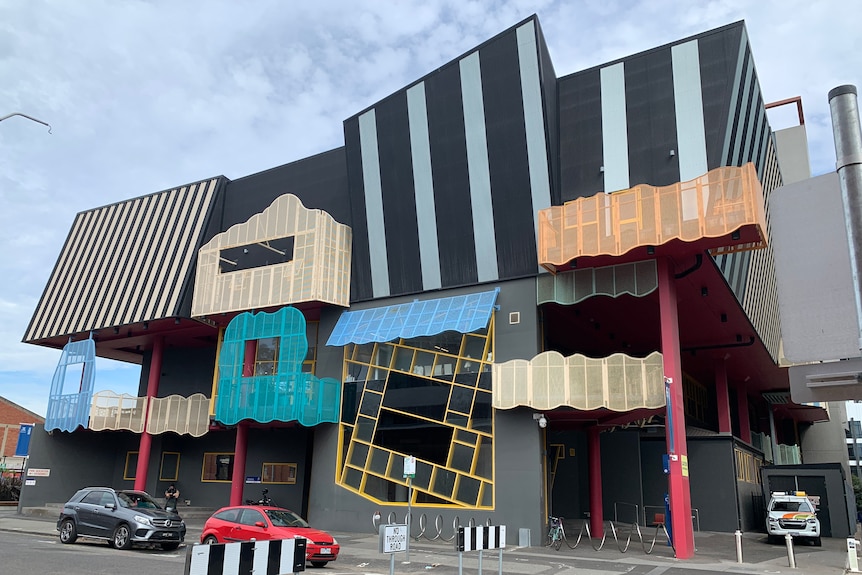 A multi-storey building with different colours and patterns on its facade