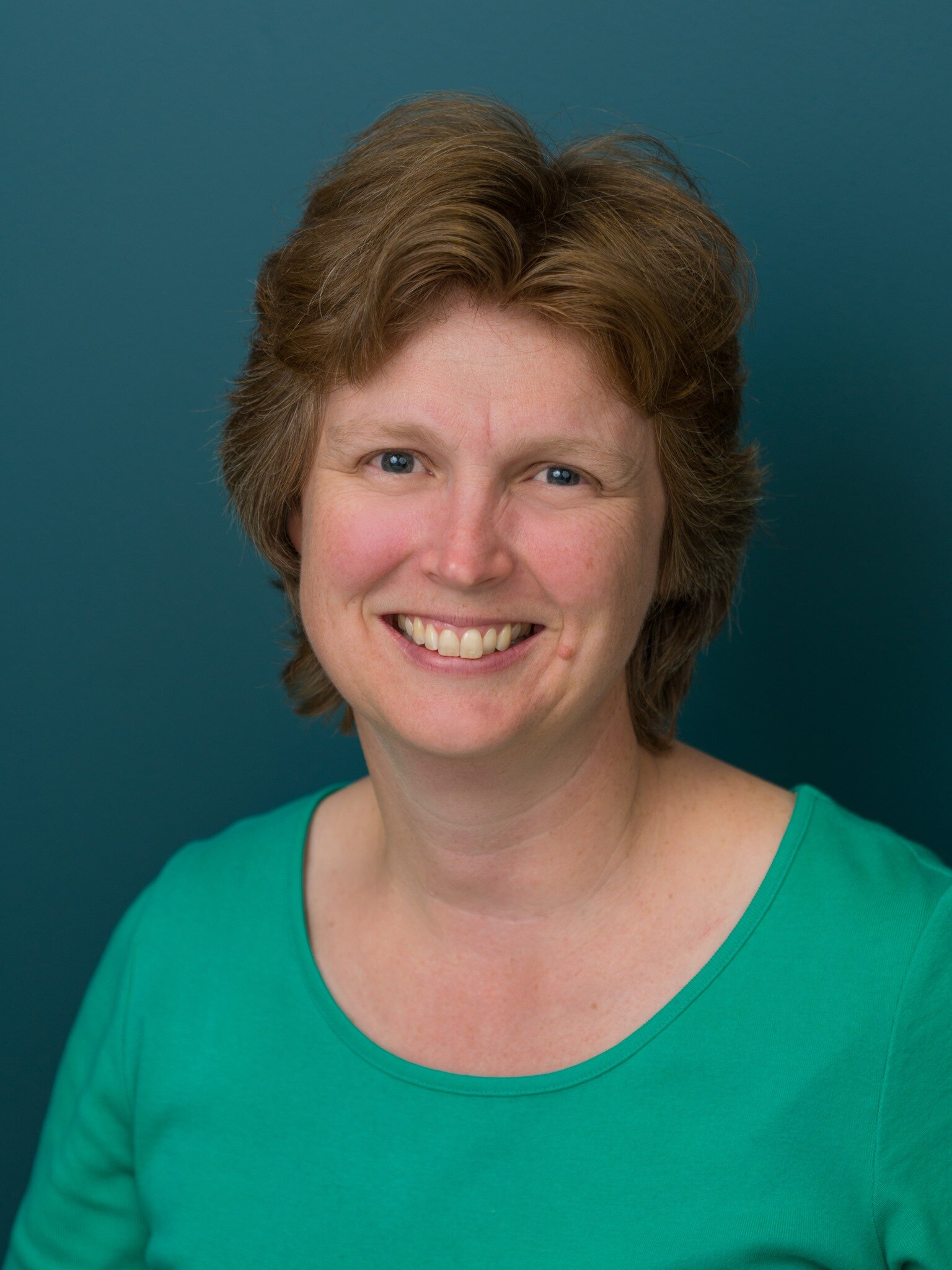 Woman in green shirt smiling