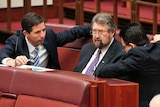 Nick Xenophon, Simon Birmingham surround Derryn Hinch in the Senate