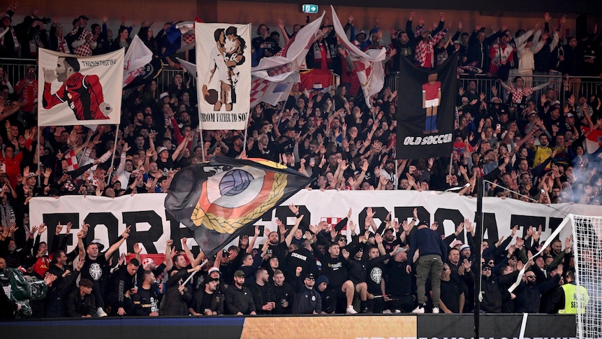 Sydney United 58 supporters hold up banners