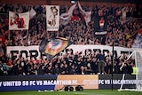 Sydney United 58 supporters hold up banners